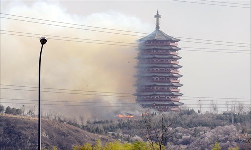 A blaze partly destroyed the Yongding Tower at the site of the 9th China (Beijing) International Garden Expo in Fengtai district Monday. Photo: CFP