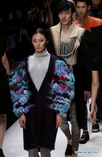 Models present creations designed by students from China Academy of Art during the 1st China Graduate Fashion Week in Beijing, capital of China, April 24, 2013. A total of 610 graduate students from 22 universities will present their designs during the five-day event which kicked off on Wednesday. (Xinhua/Li Mingfang)