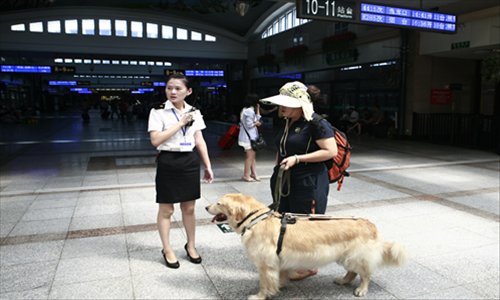 August 15, 2012, Ping Yali speaks with a member of staff as she enters the station. Photo: Li Hao/GT