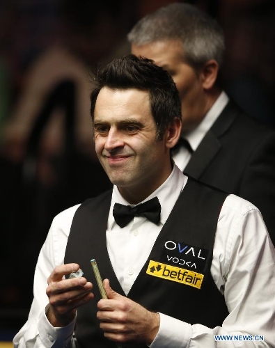Ronnie O'Sullivan of England reacts during the final of 2013 World Snooker Championship at the Crucible Theatre in Sheffield, Britain, May 6, 2013. Ronnie O'Sullivan seals his fifth world title by defeating Barry Hawkins of England with 18-12 in the final.(Xinhua/Wang Lili) 