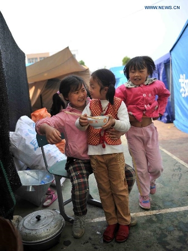 Girls eat breakfast at a temporary settlement for quake-affected people in Lushan Middle School in Lushan County, southwest China's Sichuan Province, April 26, 2013. A 7.0-magnitude jolted Lushan County on April 20. (Xinhua/Li Wen) 