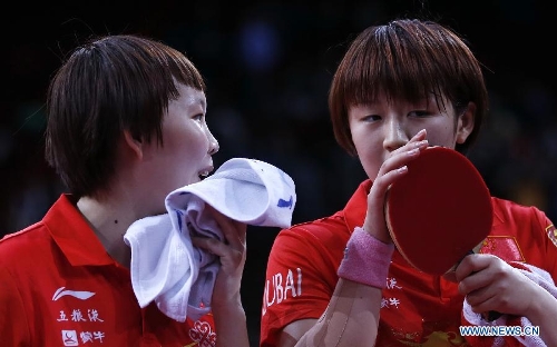 Chen Meng (R) and Zhu Yuling of China communicate during the semifinal of women's doubles against their teammates Ding Ning and Liu Shiwen at the 2013 World Table Tennis Championships in Paris, France on May 19, 2013. Chen Meng and Zhu Yuling lost 3-4.(Xinhua/Wang Lili) 