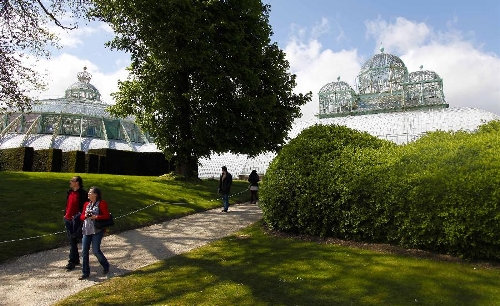 Residents and tourists visit the Royal Greenhouse of Laeken in the royal garden in Brussels, capital of Belgium, May 10, 2013. The Belgian royal family opens its greenhouses in the royal garden with wide variety of flowers to the public for three weeks every year. (Xinhua/Zhou Lei) 