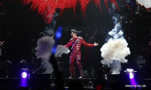 Chinese-American singer-songwriter Leehom Wang performs during Leehom Wang Music Man II-Open Fire at O2 Arena in London, Britain, April 15, 2013. (Xinhua/Wang Lili)  