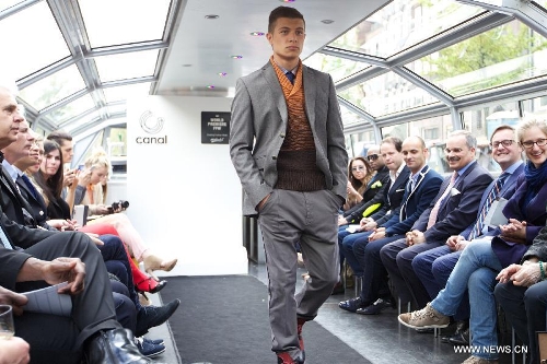 A model presents a creation on a canal boat in Amsterdam, the Netherlands, on May 22, 2013. The event