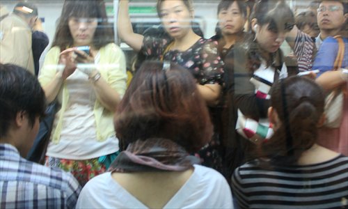 Passengers wait while trapped at the Jiaomenxi Station on Line 4 of the Beijing subway on Monday morning.  Photo: CFP