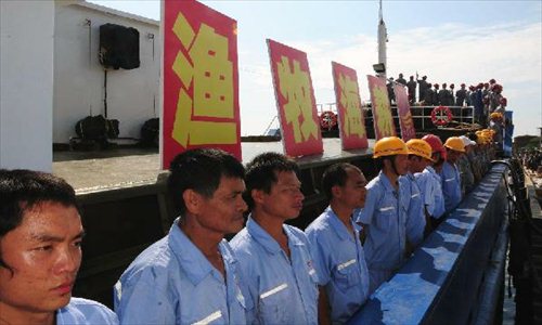 Crew members of a fishing fleet prepare to set sail to Nansha Islands at the Baimajing Harbor in Danzhou City, south China's Hainan Province, May 6, 2013. Thirty Chinese fishing vessels on Monday set off for the Nansha Islands in the South China Sea. The fishing ships, each with a capacity exceeding 100 tonnes, will stay around the Nansha Islands for 40 days. Photo: Xinhua