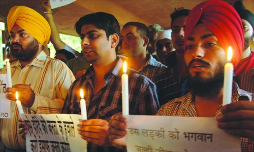 Indian protesters from the International Human Rights Organization hold candles during a demonstration in Amritsar on Saturday, against the rape of a 5-year-old girl in New Delhi. Photo: AFP