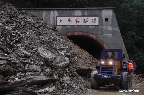 Rescuers open up landslide-blocked Damazhuang tunnel on 302 provincial road in Beichuan Qiang Autonomous County, southwest China's Sichuan Province, July 9, 2013. Downpours have submerged the quake-razed old town ruins of Beichuan, which was hit by an 8.0-magnitude earthquake in May 2008. (Xinhua)
