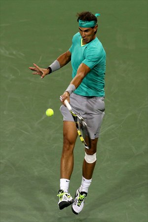 Rafael Nadal hits a return to Ryan Harrison during day four of the BNP Paribas Open on Saturday. Photo: AFP