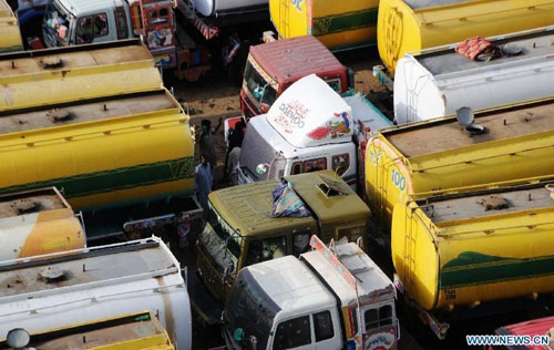 Oil tankers used to transport fuel to NATO forces in Afghanistan are seen at NATO supply terminal in southern Pakistani port city of Karachi, on July 3, 2012. Pakistan on Tuesday night announced that it is reopening land routes for NATO forces in neighboring Afghanistan after US Secretary of State, Hillary Clinton, apologized over the killing of 24 Pakistani soldiers in last November air strike, the country's Information Minister, Qamar-uz-Zaman Kaira said. Photo: Xinhua