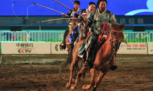 Horsemen stage an equestrian performance at the opening ceremony of the second Ordos Dalate International Horse Culture Festival in Dalate Banner of Ordos, north China's Inner Mongolia Autonomous Region, August 25, 2012. Some 60 horsemen from 15 countries and regions gave performances at the festival's opening ceremony Saturday night. Photo: Xinhua