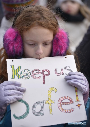 A girl holds a sign against gun violence during a march in Washington D.C., capital of the United States, Jan. 26, 2013. Thousands of people, including family members of victims and survivors of shootings at Virginia Tech University, Sandy Hook elementary school and others, took part in a march for stricter gun control laws here on Saturday. (Xinhua/Zhang Jun) 