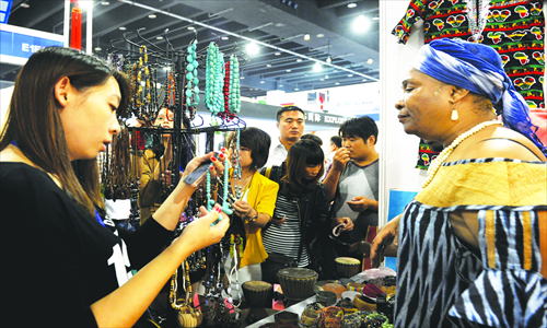 Visitors look at handicrafts exhibited at the 18th China Yiwu International Commodities Fair held last October. Photo: CFP