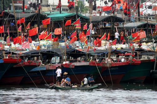 Fishermen wait at a port in Sanya, Hainan Province on Monday as typhoon Vincente approaches. Photo: CFP