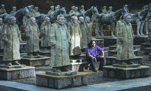 Chinese sculptor Li Chunhua sits among his sculptures of soldiers from the China Expeditionary Force (CEF) at a memorial park on Songshan Mountain in Longling county, Yunnan Province. Photo: IC