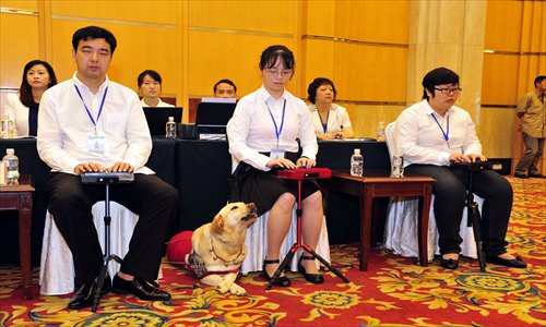Three blind stenographers work at the 6th Shanghai Disabled Persons' Federation Congress Wednesday, marking the group's first official appearance. The job has becomes a new option for the city's blind residents. So far, 147 people have taken the training. Photo: Yang Hui/GT
