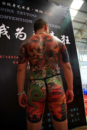 A model shows off his tattoos at an exhibition. Photo: CFP
