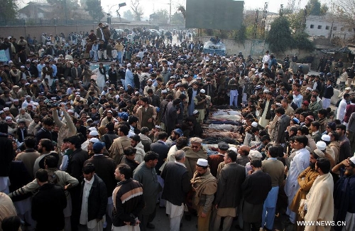 Pakistani villagers from Bara gather around the dead bodies of their relatives during a protest in northwest Pakistan's Peshawar on Jan. 16, 2013. Demonstrators said gunmen wearing military uniforms stormed homes in Bara Tehsil in Khyber Agency, some 30 kilometers from Peshawar, and shot 18 villagers dead in an overnight raid. (Xinhua/Umar Qayyum) 