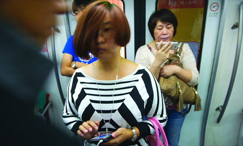 Glassy-eyed commuters may be simply tired, or might be mobile phone addicts. Photo: Li Hao/ GT