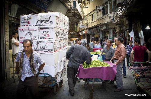 Iranians shop at Tehran's old main bazaar in downtown Tehran, Iran, on May 20, 2013. Economic condition of Iranian families is the core issue of the hopeful candidates for Iran's 11th presidential election, as the inflation rate of the Islamic republic, according to the Iranian Statistics Center, reached 29.8 percent in the first month of the current Iranian calendar year (March 21-April 20). (Xinhua/Ahmad Halabisaz) 