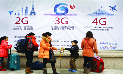 Pedestrians pass a 4G advertisement in Wuhan, capital of Central China's Hubei Province. China Mobile launched its fourth generation (4G) mobile network earlier this month. But because many users' smartphones still do not work with the faster network, the service did not become as popular as expected, China National Radio reported Sunday. Photo: CFP