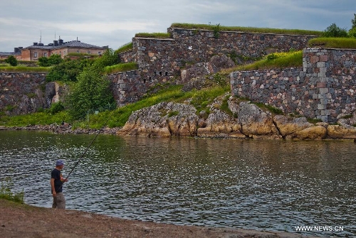 A man fishes outside the island fortress of Suomenlinna in Helsinki, capital of Finland, on June 24, 2013. Fortress of Suomenlinna is a unique historical monument and one of the largest maritime fortresses in the world. Its construction began in 1700s when Finland was part of the Kingdom of Sweden. As an example of European military architecture of its time, Suomenlinna was included in UNESCO's World Heritage List in 1991. (Xinhua/Yan Ting) 