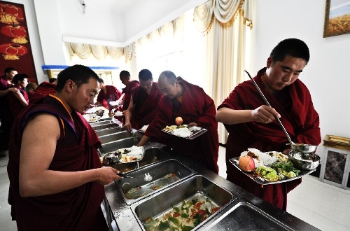 Monks have dinner in the Tibet Buddhist Theological Institute in the township of Nyetang, Lhasa, capital of southwest China's Tibet Autonomous Region. Featuring a distinctive Tibetan architecture style, the institute was opened in October 2011 and has 150 students including tulkus and monks from various Tibetan Buddhist sects. (Xinhua/Purbu Zhaxi)