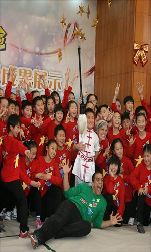 Dufftin Garcia (bottom) and Kay Gayner with children from the Dancing into the Future program in Minhang Photo: Courtesy of Helen Stambler Neuberger