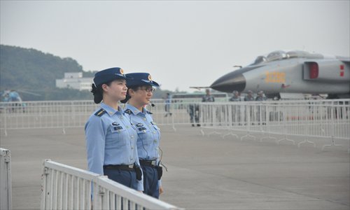 Two People’s Liberation Army Air Force soldiers guard a Xi’an JH-7A fighter bomber in Zhuhai, Guangdong Province Sunday. The air force sent at least nine China-made combat aircraft to Airshow China 2012. Photo: GT/Xu Tianran
