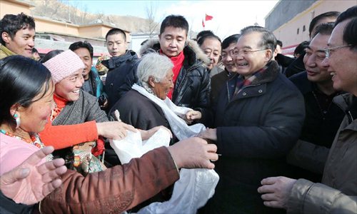 Chinese Premier Wen Jiabao greets residents in a community in Yushu Tibetan Autonomous Prefecture in northwest China's Qinghai Province, December 31, 2012. Wen paid a visit in quake-hit Yushu before New Year's Day to inspect the reconstruction work and extend New Year's greetings to the people there. The prefecture witnessed a devastating earthquake in 2010. Photo: Xinhua
