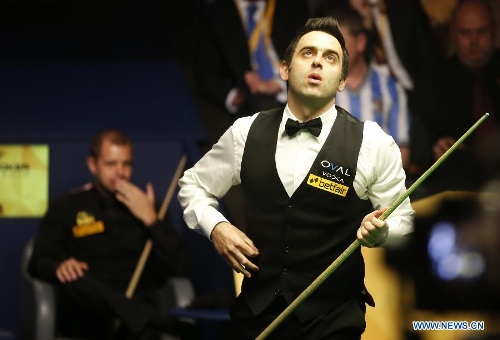Ronnie O'Sullivan of England reacts during the final of 2013 World Snooker Championship at the Crucible Theatre in Sheffield, Britain, May 6, 2013. Ronnie O'Sullivan seals his fifth world title by defeating Barry Hawkins of England with 18-12 in the final.(Xinhua/Wang Lili) 