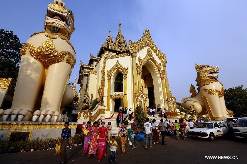 People are seen on the first day of Myanmar new calendar year at the world-famous Shwedagon Pagoda in Yangon, Myanmar, April 17, 2013. On Myanmar new year's day, people in the country used to perform meritorious deeds and Buddhists, who account for the majority of the people, usually go to the pagodas, monasteries and meditation centers where they practice meditation. (Xinhua/U Aung) 