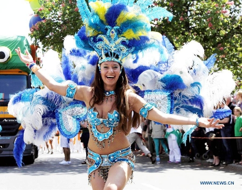 A dancer in a florid costume performs at the grand parade of the 2013 Berlin Carnival of Cultures Festival, in Kreuzberg District of Berlin, Germany, May 19, 2013. More than 4,000 revelers representing the ethnic communities from some 80 countries and regions in Berlin took part in the annual parade on Sunday, showcasing the cultural diversity and affluence of the German capital. (Xinhua/Pan Xu) 