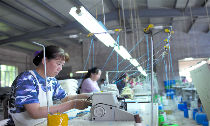 Women work in a textile processing plant in Tumen, Yanbian Korean Autonomous Prefecture, Jilin Province. Photo: CFP