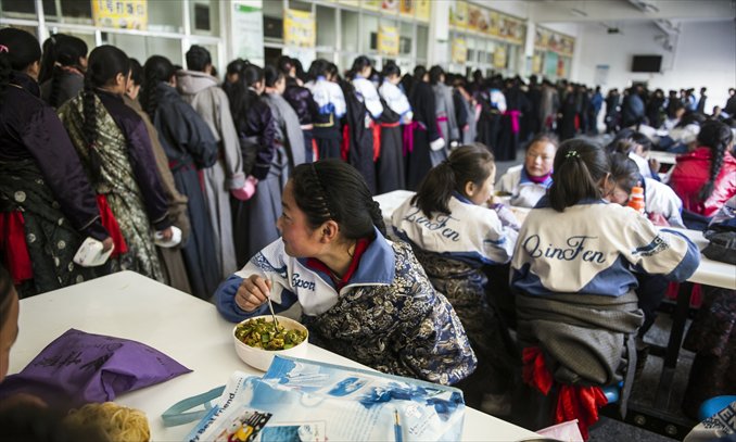 Students have lunch in a cafeteria at Hezuo No.3 High School in Gannan, Gansu Province on March 7.