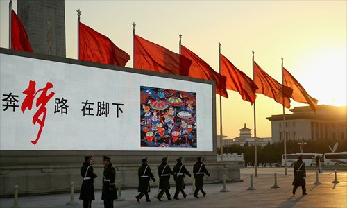 Red flags billow outside the Great Hall of the People in central Beijing where the Communist Party of China Central Committee gathered for a plenum on November 12. Photo: CFP