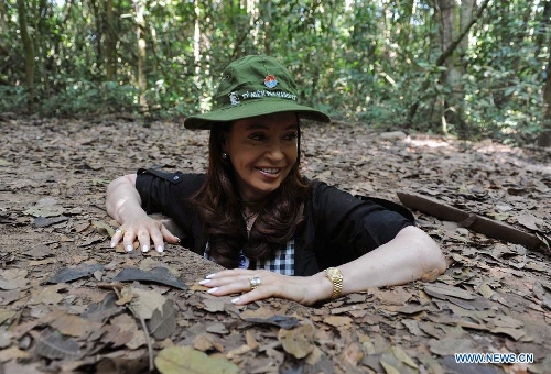 President of Argentina Cristina Fernandez enters a war tunnel during her visit to the Cu Chi tunnels and the Museum of War against United States near Ho Chi Minh City, Vietnam, Jan. 19, 2013. The Cu Chi tunnels is a complex underground system built by the Vietnamese during the French occupation and expanded after the American invasion in the 1960's. Fernandez arrived in Vietnam Friday after official visits to the United Arab Emirates and Indonesia. (Xinhua/Daniel Dabove/TELAM) 