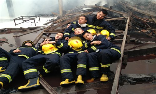 Firefighters take a rest after a long battle with a factory fire. Photo: Courtesy of Shanghai Municipal Fire Bureau