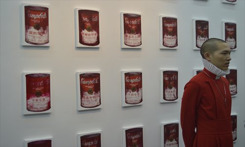 Artist Mei Le poses in front of his artwork <em>Campbell Soup Special for China</em> series. Photos: Courtesy of Moproo 