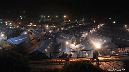 Tents are seen at an allocation area after earthquakes in Yiliang County, Southwest China's Yunnan Province, September 8, 2012. Two earthquakes measuring over 5 struck Yiliang County on Friday. Local authorities have taken measures to provide victims with relief materials including food, water and tents. Photo: Xinhua