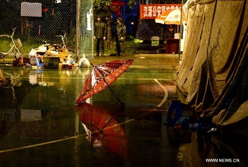 An umbrella is seen in rain outside a tent at a temporary settlement for quake-affected people in Lushan County, southwest China's Sichuan Province, April 23, 2013. A rainfall hit Lushan on Tuesday, the fourth day after a 7.0-magnitude jolted the county on April 20. (Xinhua/Li Gang) 