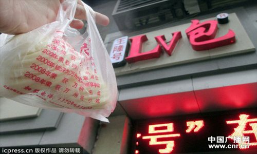 A customer holds steam buns purchased at the newly-renamed 