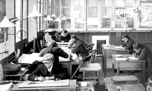 Indoor gas lights help clerical workers in an early 20th century office.