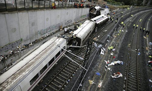 Rescuers, forensic experts and police officers work at the site of a train accident near the city of Santiago de Compostela on Thursday. A train hurtled off the tracks on Wednesday in northwest Spain, killing at least 80 passengers and injuring more than 140. Photo: AFP/ HO