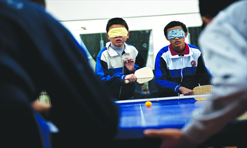 Xiao (right) plays doubles with his teammate.