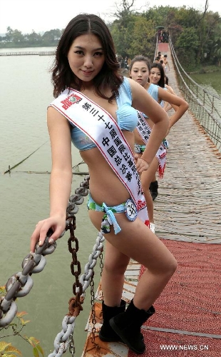 A contestant of the 37th Miss Bikini International Competition poses for a photo in Qixingyan scenery spot in Zhaoqing, south China's Guangdong Province, Jan. 10, 2013. The China final of the competition kicked off here on Jan. 9. (Xinhua/Li Mingfang) 