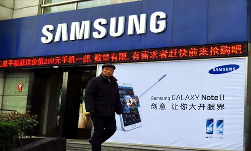 A passenger walks past a Samsung store in Shanghai. Photo: CFP 