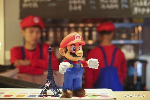 Waiters in the costume of Super Mario, a famous video game character, work at a Mario themed restaurant in Tianjin, north China, April 8, 2013. The restaurant that opened on Monday attracted many young customers due to its 