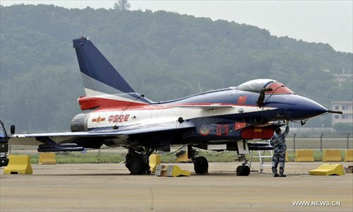 A maintenance staff member of Bayi Aerobatic Team of the People's Liberation Army (PLA) Air Force, checks a plane in Zhuhai, south China's Guangdong Province, November 12, 2012. The 9th China International Aviation and Aerospace Exhibition will kick off on Tuesday in Zhuhai. Photo: Xinhua
